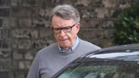 Former British ambassador to the US Peter Mandelson pictured getting into a vehicle 