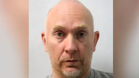 Met Police Wayne Couzens, a man in his 40s, bald, with some facial hair 