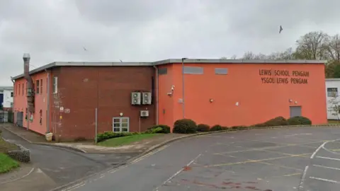 Exterior of Lewis School Pengam - a large red building 