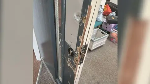 Sunderland Mind One of the doors that was damaged in the burglaries at Sunderland Mind. There folders and storage containers in the background.