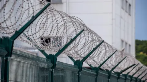 Getty Images Barbed wire outside a prison 