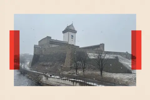 Narva city in Estonia, a snowy image by a river
