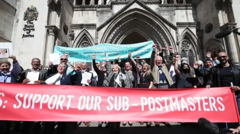 A group of sub-postmasters outside a court
