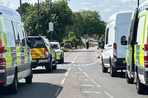 A GV of police vehicles and officers in Stenson Road, Derby, on the morning of 16 June 2025