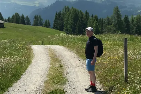 Paul Luckock A man hikes on a mountainside 