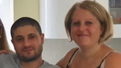 Essex Police Giuseppe Morreale and Maria Ricotta. Mr Morreale has a beard and short black hair. Mrs Ricotta has short blonde hair. They are both smiling at the camera.