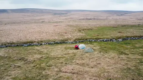 John Harding Two tents on open moorland.
