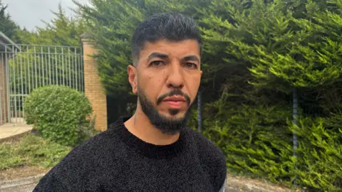 Leandro Amorim. He has dark hair and beard, wearing a black t-shirt.