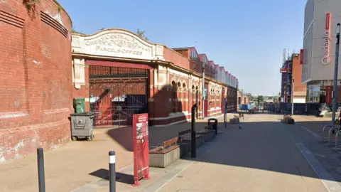 Google A street with red brick buildings.