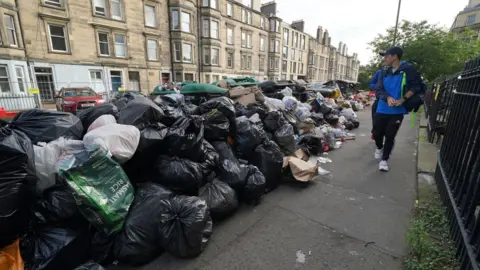 PA Media Rubbish piled up in the streets of Edinburgh during the 2022 strike 