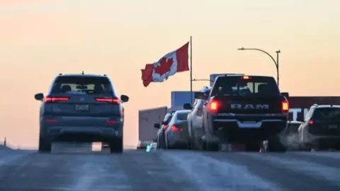 Getty Images Cars on a highway with a Canadian flag