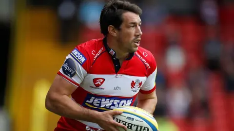 Action Images/Reuters Tom Voyce playing for Gloucester, wearing a red and white shirt and carrying a ball.