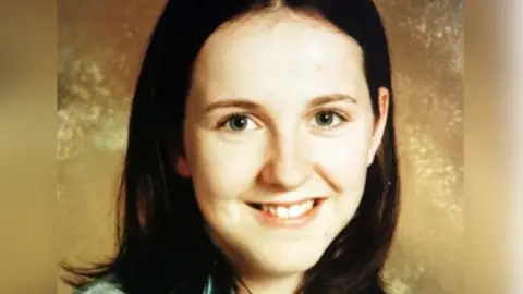 Family Handout A girl with long brown hair smiling at the camera