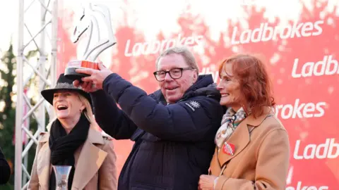 Harry Redknapp and Sandra Harris celebrate after their horse The Jukebox Man wins the King George VI Chase ridden by Jockey Ben Jones during day one of the Christmas Festival at Kempton Park Racecourse