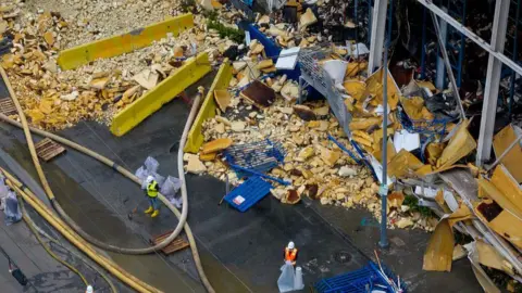 Getty Images An aerial shot of construction crews trying to clean up heaps of rotting debris