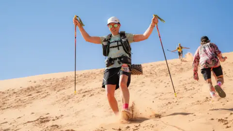 Lesley Malloch Lesley Malloch running down a sand dune.