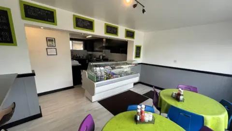 Oli Constable/BBC The inside of the cafe