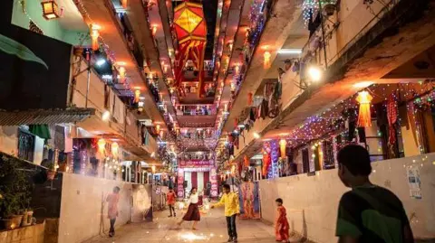 Getty Images Rows of flats illuminated with electric lights and lamps in a residential complex in Mumbai's Parel