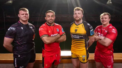 Dewi Lake, Liam Belcher, Aneurin Owen and Blair Murray promoting Judgement Day in April 2025

