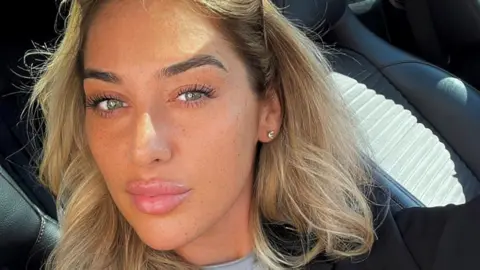 Family handout Elle Edwards takes a selfie in a car - she has long blonde hair and green eyes