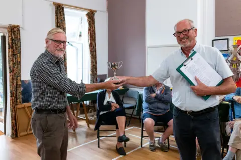 Jim Grover One of the trophies being presented