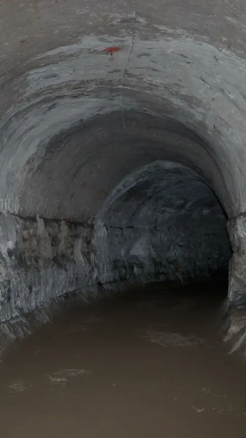 An archway in a dark underground cave