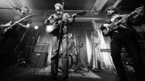Jess Greaves A black and white picture of the band playing an intimate set at London Rough Trade East.