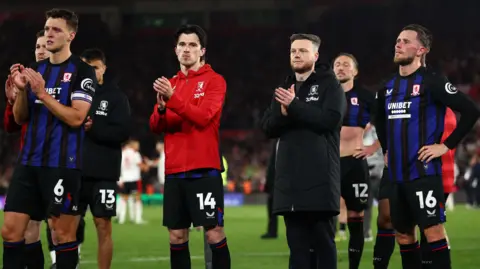Kim Hellberg manager of Middlesbrough applauds fans at full time alongside Middlesbrough players