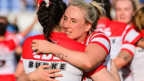 St Helens' Jodie Cunningham and Leah Burke hug in celebration at beating York Valkyrie