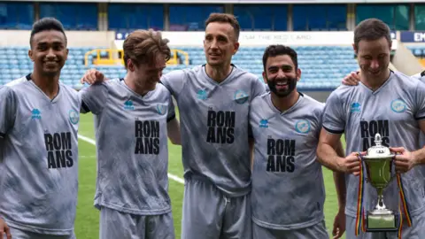 Five Millwall Romans players posing for a picture after winning the London Unity League Cup Final.