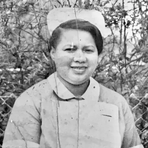 Steve Reeves A black and white photo of a woman in a nurse's outfit
