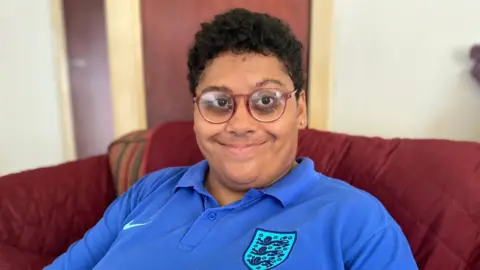 Phil Shepka/BBC Jade Archibald smiling at the camera