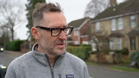 Laura Foster/BBC A man wearing glasses has a concerned face