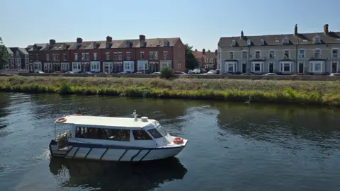 A boat on the River Taff in the sun through Cardiff 