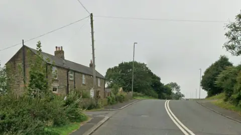 Google Lobley Hill Road, at the junction of Schoolhouse Lane, on the A692. There is a cottage to the left of the double carriageway road.