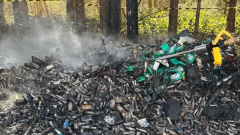 Nottinghamshire Fire and Rescue Service A close-up of a pile of scorched lithium-ion batteries