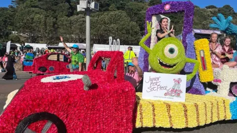 A float at a Battle of Flowers event in Jersey. It is covered in flowers with a designed based on the film Monsters Inc, with the character Mike featuring.