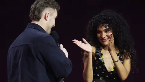 Reuters Olivia Dean congratulates song collaborator Sam Fender