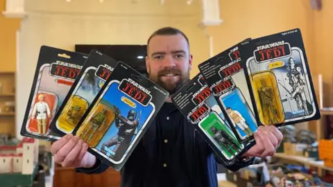 Richard Winterton Auctioneers Auctioneer with some of the lots