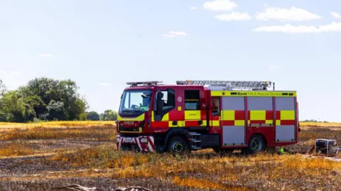 A fire engine in a burnt out field (stock image)