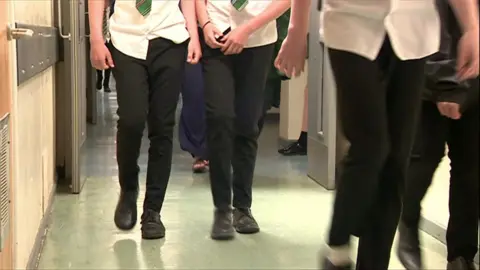 School pupils walking in corridor