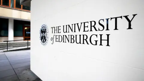 Getty Images Close up of a white and black University of Edinburgh sign with a building partially visible in the background