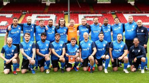 Sands United pose for a picture at The Valley stadium