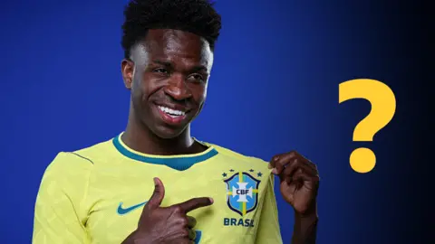 Vinicius Junior pointing to a Brazil badge on his shirt