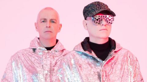 The Pet Shop Boys promotional image with a pink background