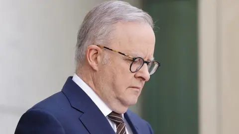 Getty Images Anthony Albanese wearing a brown tie and a navy suit