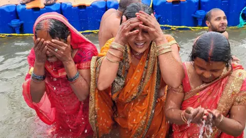 Millions begin bathing in sacred rivers during Hindu festivals in India 40 Devotees taking a dip in the river at Khumbu