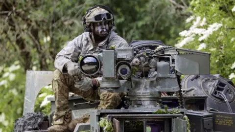 Alex Kraus/Bloomberg A US Army soldier on an M1A1 Abrams battle tank in Bavaria