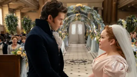 Luke Newton as Colin Bridgerton, Nicola Coughlan as Penelope Featherington in episode 307 of Bridgerton. 