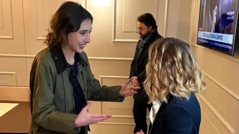 Chora Media/Reuters Italian journalist Cecilia Sala speaks with Italian Prime Minister Giorgia Meloni at Rome's Ciampino military airport after she was freed from detention in Iran, in Rome, Italy, January 8